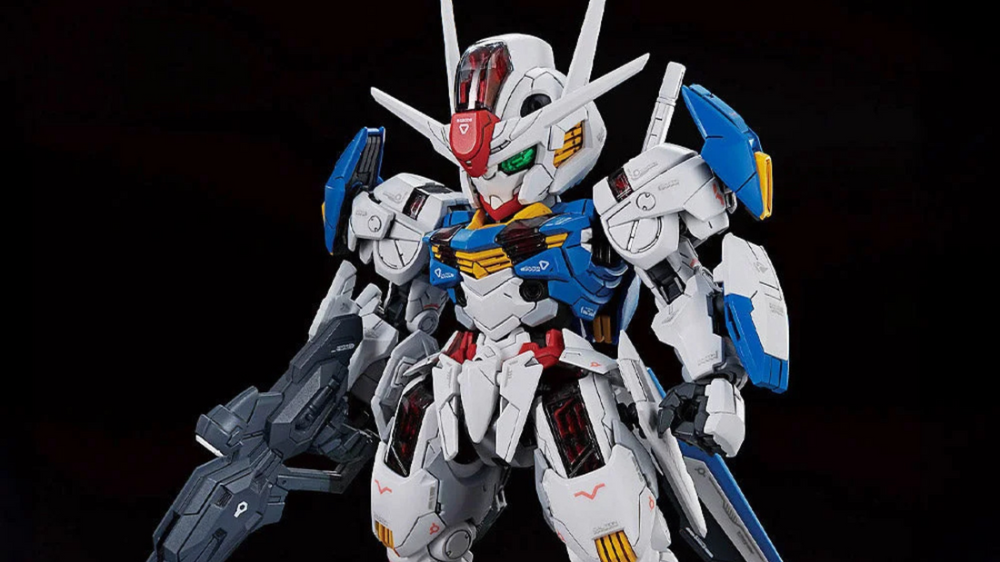 MGSD Gundam Aerial model kit posed with beam rifle and shield bits, featuring white, blue and red armor, metallic inner frame details and clear Shell Unit panels.