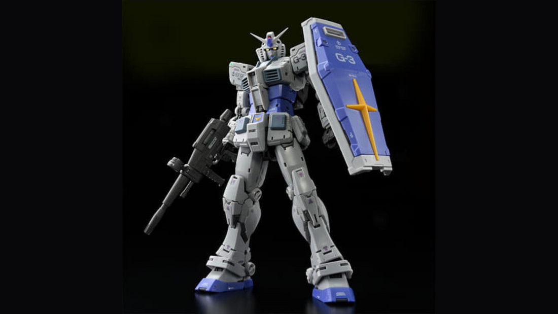 RG 1/144 G-3 Gundam Ver. 2.0 in gray-and-blue, front three-quarter pose with beam rifle and blue shield on a black studio background.
